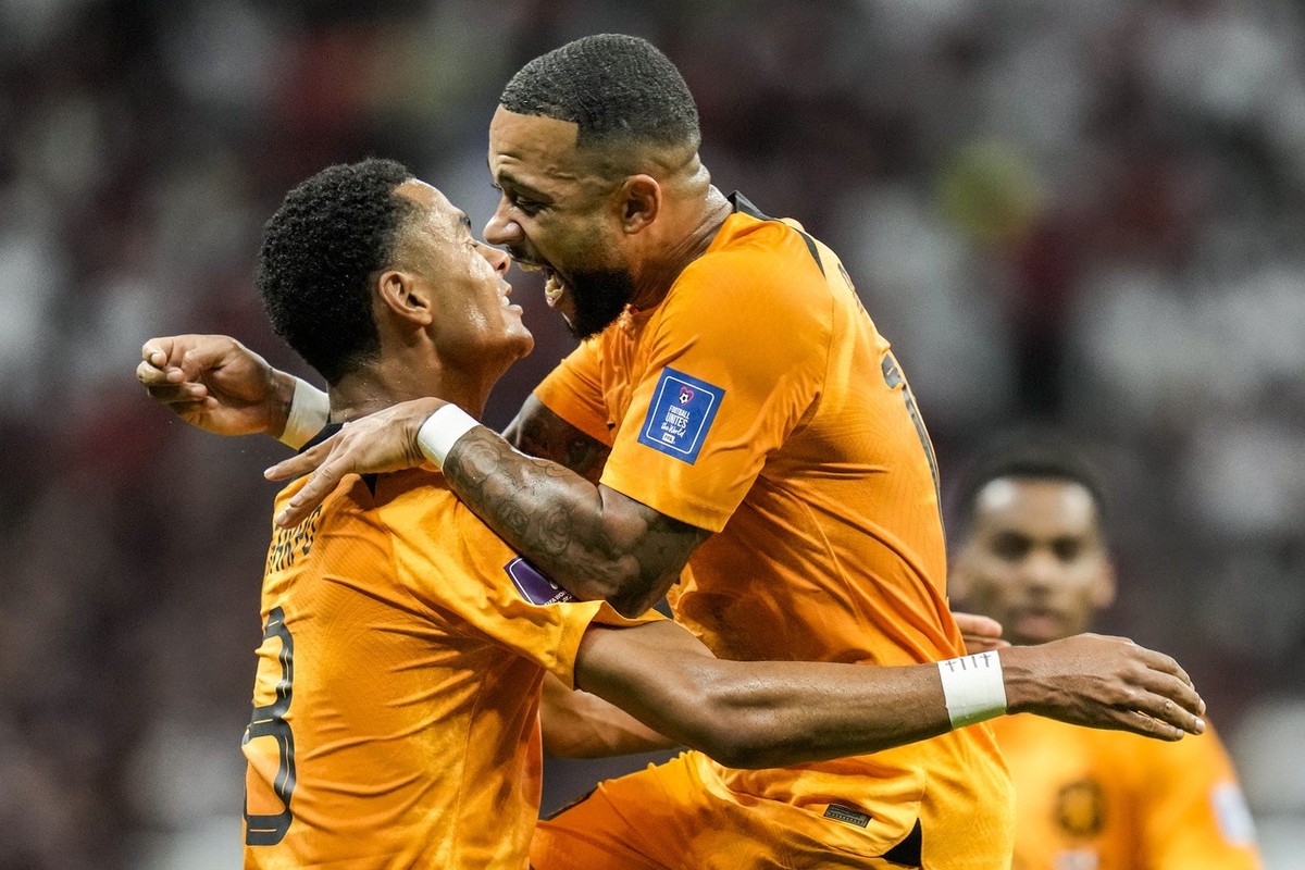 Cody Gakpo of the Netherlands celebrates after scoring his side's opening goal during the World Cup group A soccer match between the Netherlands and Qatar, at the Al Bayt Stadium in Al Khor , Qat ...