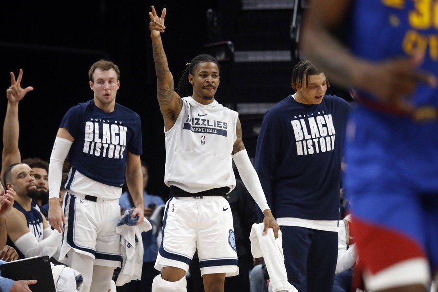 NBA, Basketball Herren, USA Denver Nuggets at Memphis Grizzlies Feb 25, 2023 Memphis, Tennessee, USA Memphis Grizzlies guard Ja Morant 12 reacts from the bench during the first half against the Denver ...