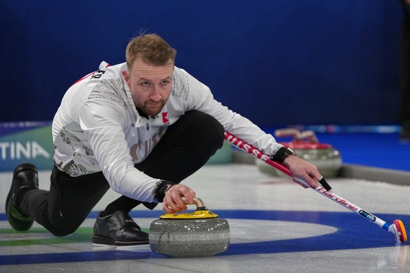 Switzerland's Yannick Schwaller in action during the men's curling round robin session against Britain, at the 2026 Winter Olympics, in Cortina d'Ampezzo, Italy, Sunday, Feb. 15, 2026.  ...
