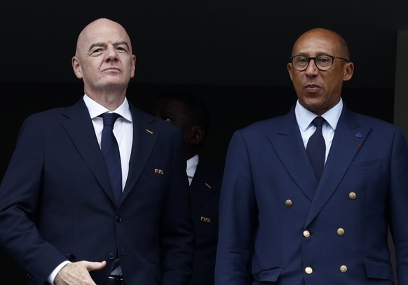epa13057401 (L-R) Iraq Football Association President Younis Mahmoud, FIFA President Gianni Infantino, and French Football Federation President Philippe Diallo attend the FIFA World Cup 2026 group sta ...