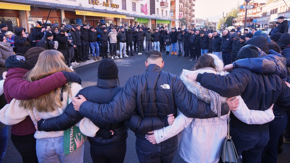 People gather during a memorial procession in Crans-Montana, Swiss Alps, Switzerland, Sunday, Jan. 4, 2026, after a devastating fire in Le Constellation bar left dead and injured during the New Year&# ...