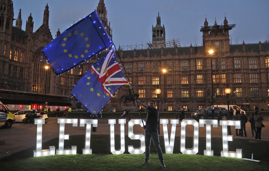 1.2 metre-tall illuminated letters reading &quot;LET US VOTE&quot; are set up outside Parliament by the public and civic organisation Avaaz in London, Wednesday, March 27, 2019. British lawmakers were ...