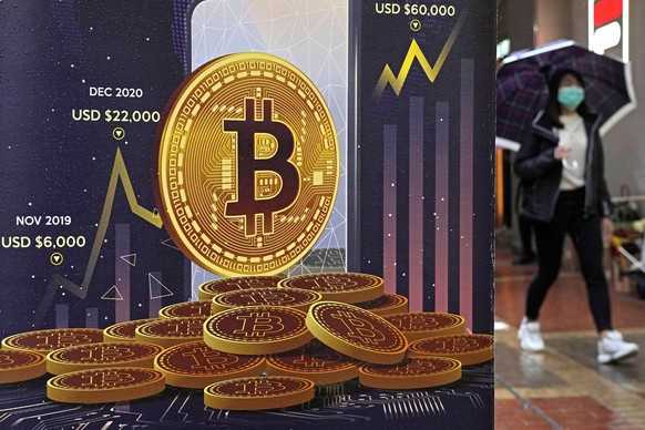 FILE - An advertisement for Bitcoin cryptocurrency is displayed on a street in Hong Kong, on Feb. 17, 2022. Bitcoin briefly hit an all-time high Tuesday, March 5, 2024, with the world&#039;s largest c ...