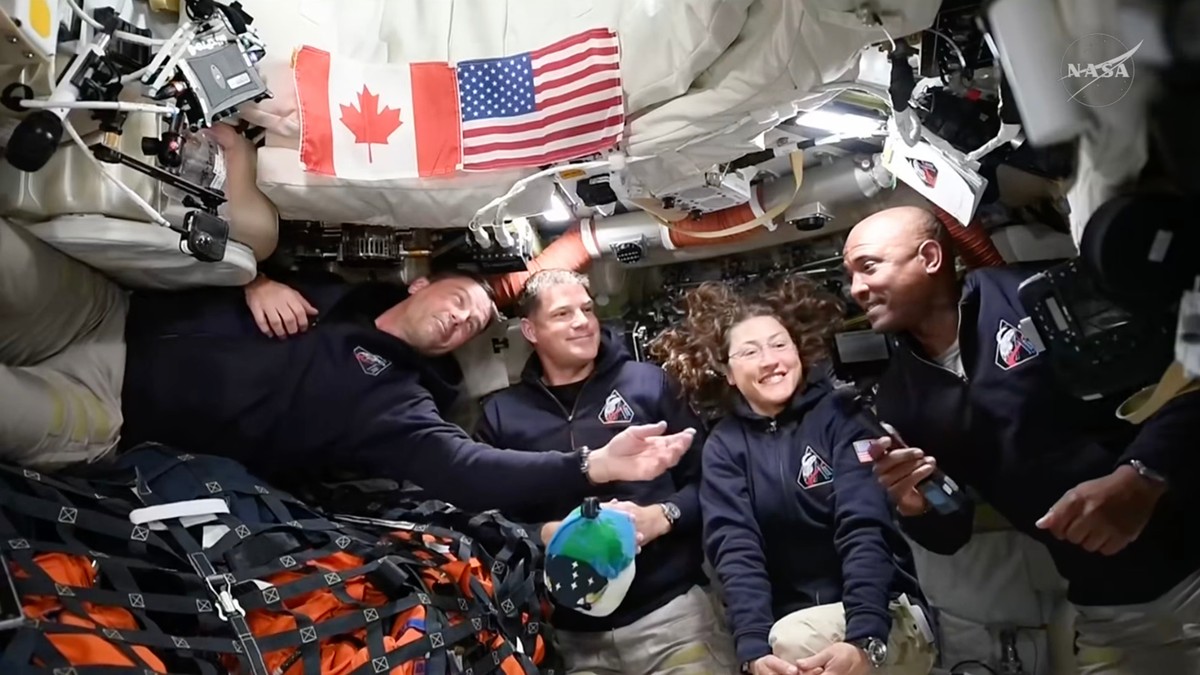 In this image from video provided by NASA, Artemis II astronauts, from left, Reid Wiseman, Jeremy Hansen, Christina Koch and Victor Glover gather for an interview en route to the moon on Saturday, Apr ...