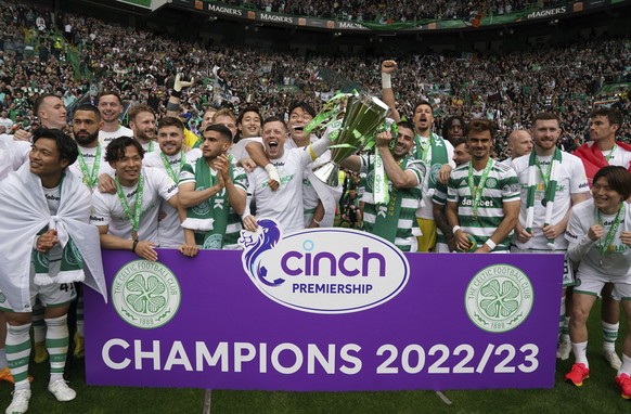 Celtic players celebrate with the trophy after winning the Scottish Premiership, at Celtic Park, Glasgow, Scotland, Saturday, May 27, 2023. (Andrew Milligan/PA via AP)
