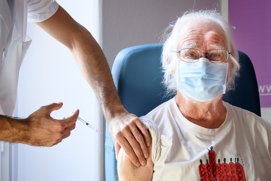 A nurse administers the Pfizer-BioNTech COVID-19 vaccine to 2017 Nobel Prize in Chemistry Swiss professor Jacques Dubochet during the vaccinations against the coronavirus disease (COVID-19) on the ope ...