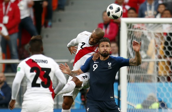 France&#039;s Olivier Giroud, right, is airborne with Peru&#039;s Alberto Rodriguez during the group C match between France and Peru at the 2018 soccer World Cup in the Yekaterinburg Arena in Yekateri ...