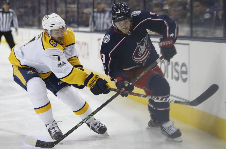 Nashville Predators&#039; Yannick Weber, left, of Switzerland, knocks the puck away from Columbus Blue Jackets&#039; Artemi Panarin, of Russia, during the second period of an NHL hockey game Tuesday,  ...