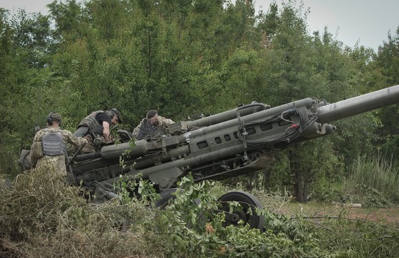 Ukrainian soldiers prepare to fire at  Russian positions from a U.S.-supplied M777 howitzer in Ukraine's eastern Donetsk region Saturday, June 18, 2022. (AP Photo/Efrem Lukatsky)