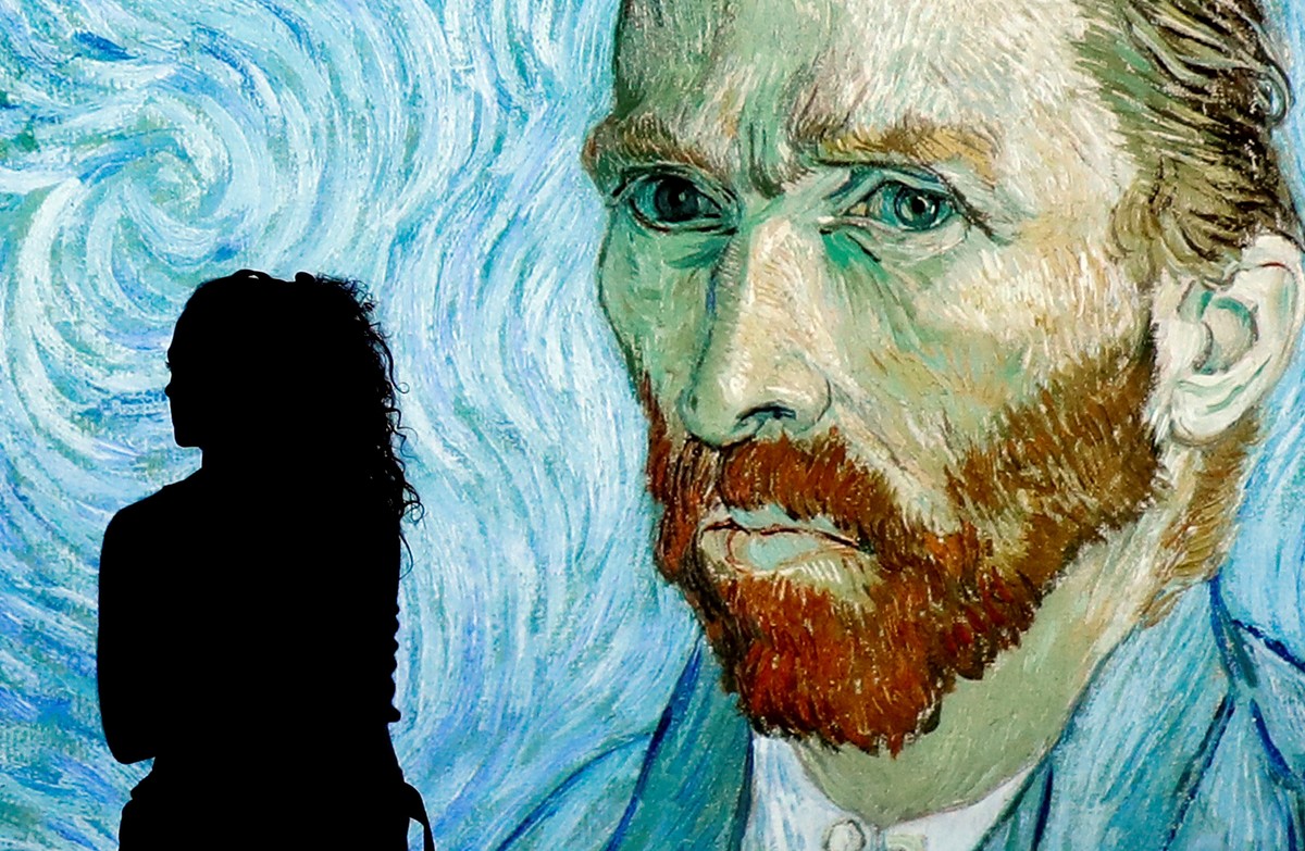 epa07436579 A visitor stands in front of a projection depicting Dutch post-impresionist painter Vincent Van Gogh during the press preview of the interactive 'Meet Vincent Van Gogh Experience' ...