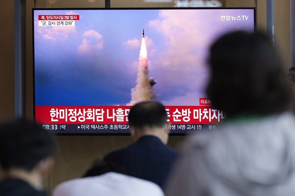 People watch a TV screen showing a news program reporting about North Korea&#039;s missile launch with file image, at a train station in Seoul, South Korea, Wednesday, May 25, 2022. North Korea launch ...