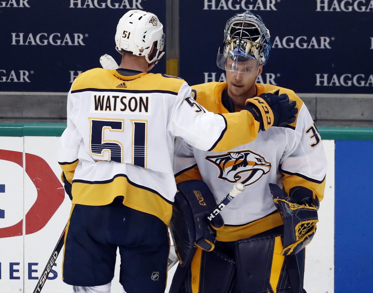 Nashville Predators' Austin Watson (51) taps goaltender Pekka Rinne, right, on the shoulder as they stand by the bench following their 2-1 overtime loss to the Dallas Stars in Game 6 of an NHL ho ...