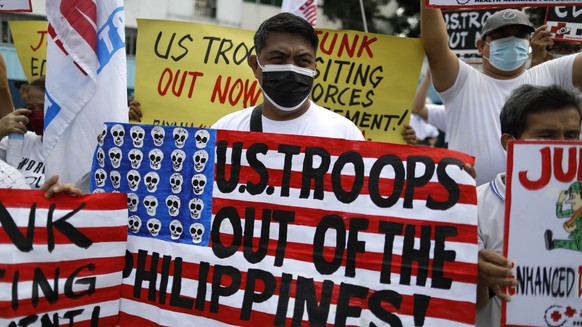 epa10443720 Protesters hold a rally to express opposition to a visit by US Defense secretary Lloyd Austin, outside a military camp in Quezon City, Philippines, 02 February 2023. The protesters are aga ...