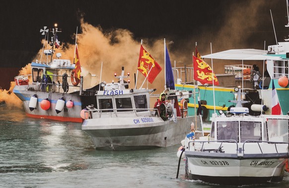 FILE - French fishing vessels block the port of Jersey in protest Thursday, May 6, 2021. France has threatened to bar British boats from some of its ports and tighten checks on boats and trucks carryi ...