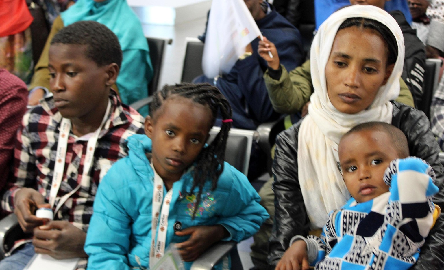 epa06843913 139 refugees from the Horn of Africa that includes 134 Eritreans and five Somalians, who were refugees in the Tigray camps in Ethiopia arrive at the airport Leonardo Da Vinci airport in Fi ...