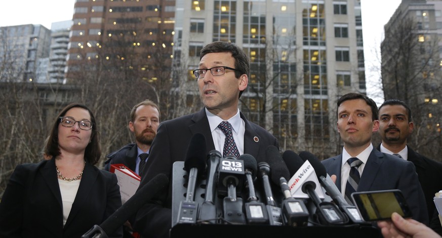 Washington Attorney General Bob Ferguson, center, talks to reporters as Solicitor General Noah Purcell, second from right, looks on, Friday, Feb. 3, 2017, following a hearing in federal court in Seatt ...