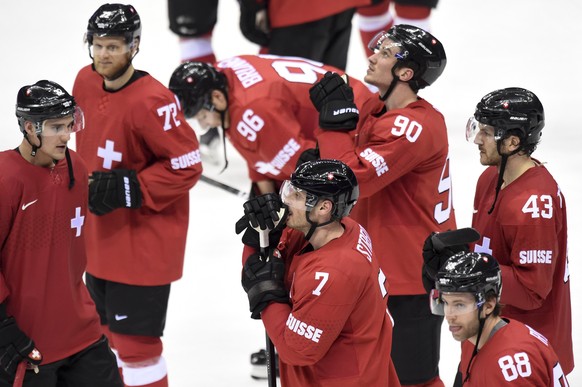 Switzerland&#039;s players, from left, Ivo Ruethemann, Patrick von Gunten, Damien Brunner, Mark Streit, Roman Josi, Kevin Romy and Morris Trachsler are disappointed after they loose the men&#039;s pre ...