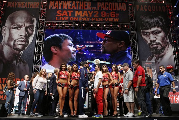 Floyd Mayweather Jr., center left, and Manny Pacquiao pose during their weigh-in on Friday, May 1, 2015 in Las Vegas. The world weltherweight title fight between Mayweather Jr. and Pacquiao is schedul ...