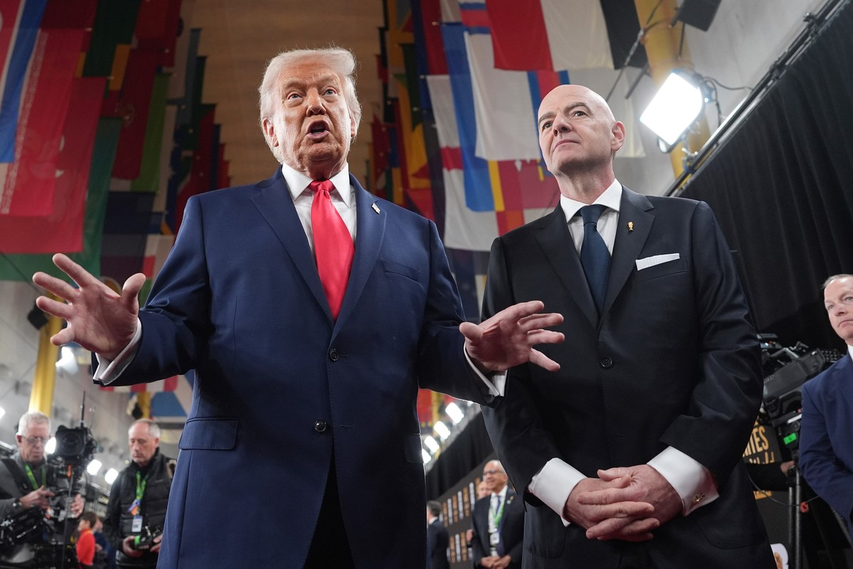 KEYPIX - President Donald Trump, center, speaking to members of the media during his arrival with FIFA President Gianni Infantino, right, at the Kennedy Center for the 2026 FIFA World Cup draw, Friday ...