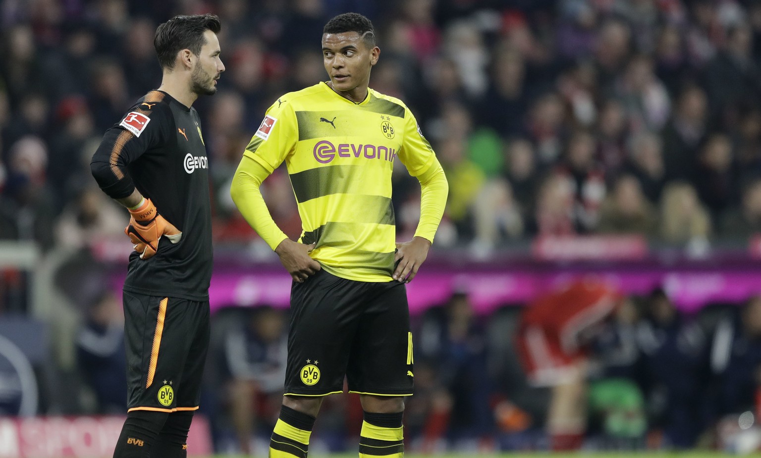 Dortmund goalkeeper Roman Buerki, left, talks to team mate Manuel Akanji during the German Bundesliga soccer match between FC Bayern Munich and Borussia Dortmund in Munich, Germany, Saturday, March 31 ...