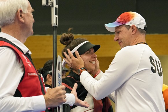 Switzerland&#039;s Chiara Leone, center, is congratulated after she won the gold medal in the 50m rifle 3 positions women?s final at the 2024 Summer Olympics, Friday, Aug. 2, 2024, in Chateauroux, Fra ...