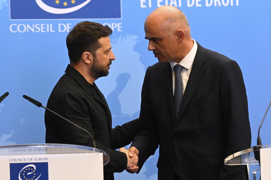 Ukraine&#039;s President Volodymyr Zelenskyy, left, shakes hands with Alain Berset, secretary General of the Council of Europe, as he arrives for a press conference at the Council of Europe after sign ...