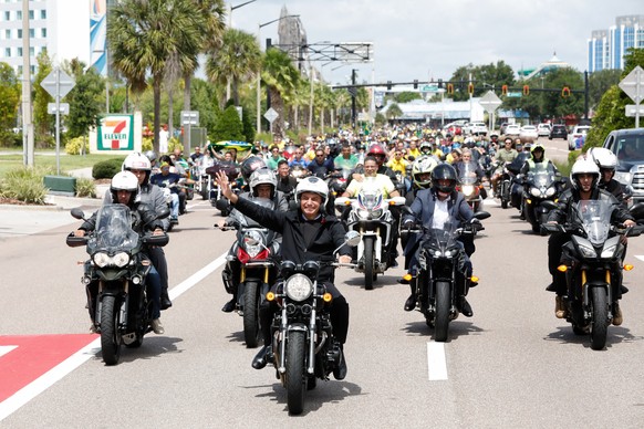 epa10008899 A handout photo made available by the Planalto Palace, seat of the executive power of the Brazilian Federal Government, shows the president of Brazil, Jair Bolsonaro (C), leading a motorcy ...