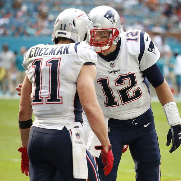 epa07220460 New England Patriots Julian Edelman (L) celebrates his touchdown with quarterback Tom Brady (R)against the Miami Dolphins during the first half of their NFL American Football game at Hard  ...