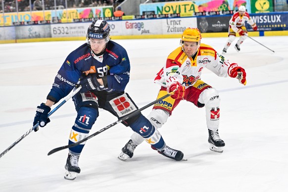 Dario Wuethrich (HCAP) protects the puck along the boards from PostFinance Top Scorer Toni Rajala (EHCB), during the regular season of National League A (NLA) Swiss Championship 2024/25 between HC Amb ...
