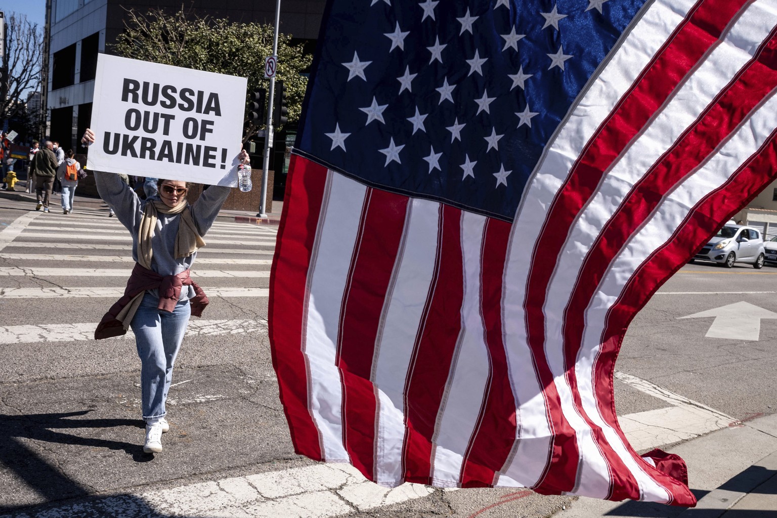 Protestors calling for a stop to the Russian invasion of Ukraine appeal to motorists outside of the federal building in Los Angeles Thursday, Feb. 24, 2022. (David Crane/The Orange County Register via ...