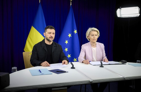 epa12307199 A handout picture made available by the Presidential Press Service shows European Commission Ursula van der Leyen (R) and Ukraine&#039;s President Volodymyr Zelensky (L) attend a video con ...