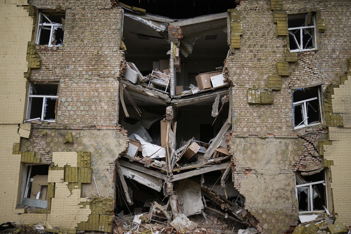 Debris hangs from a residential building heavily damaged in a Russian bombing in Bakhmut, eastern Ukraine, eastern Ukraine, Saturday, May 28, 2022. Fighting has raged around Lysychansk and neighbourin ...