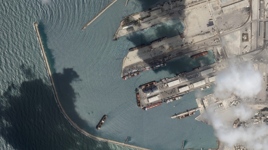 This satellite image from Planet Labs PBC shows the Sierra Leone-flagged cargo ship Razoni, center bottom with four white cranes on its red deck, at port in Tartus, Syria, Monday, Aug. 15, 2022. The f ...
