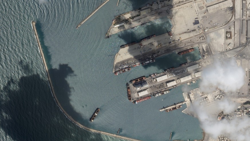 This satellite image from Planet Labs PBC shows the Sierra Leone-flagged cargo ship Razoni, center bottom with four white cranes on its red deck, at port in Tartus, Syria, Monday, Aug. 15, 2022. The f ...