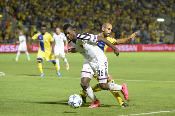 Basel&#039;s Breel Embolo, front, fights for the ball against Maccabi&#039;s Gal Alberman, back, during an UEFA Champions League play-off round second leg soccer match between Israel&#039;s Maccabi Te ...