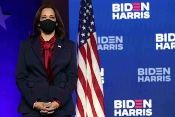 Democratic vice presidential candidate Sen. Kamala Harris, D-Calif., listens as Democratic presidential candidate former Vice President Joe Biden speaks Friday, Nov. 6, 2020, in Wilmington, Del. (AP P ...