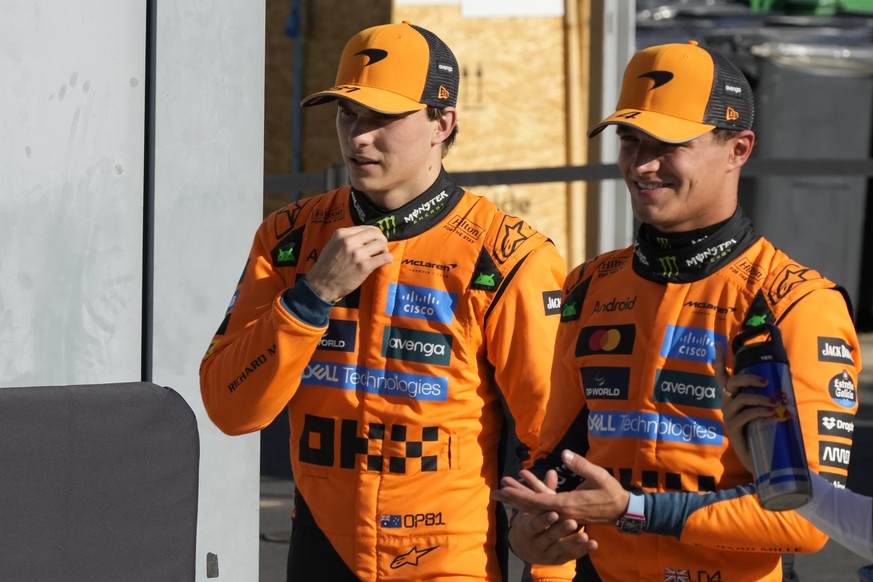 McLaren driver Oscar Piastri of Australia, left, and McLaren driver Lando Norris of Britain walk through the paddock after the qualifying session ahead of the Italian Grand Prix at the Monza racetrack ...