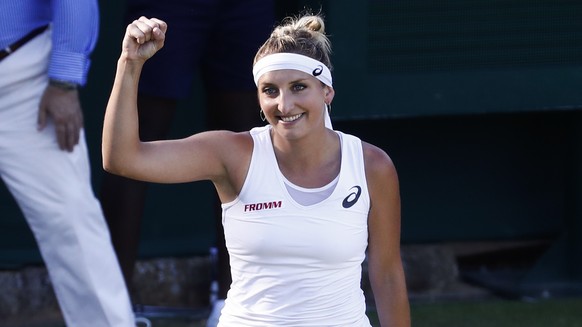 Timea Bacsinszky of Switzerland celebrates after winning her first round match against Monica Puig of Puerto Rico, at the Wimbledon Championships at the All England Lawn Tennis Club, in London, Britai ...