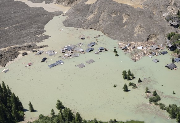 KEYPIX - Water from the Lonza river flows over the mud and stone, to form of a lake flooding the last houses of the village of Blatten, Switzerland, Friday, May 30, 2025. A large part of the village o ...