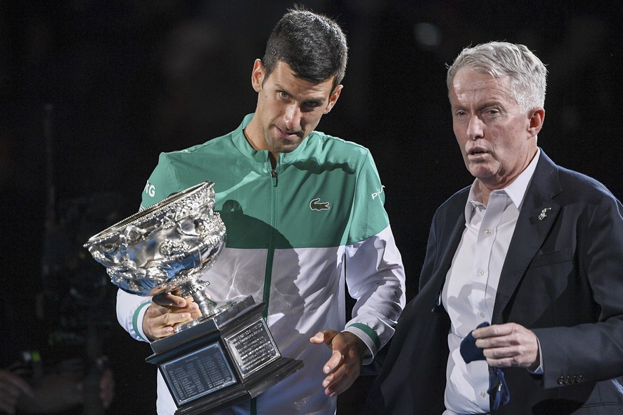 Serbia&#039;s Novak Djokovic, left, stands with Australian Open tournament director Craig Tiley during the trophy presentation at the Australian Open tennis championships in Melbourne, Australia, Sund ...