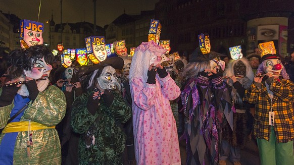 Revellers wearing lanterns parade through the streets at the carnival procession of Basel, Switzerland, Monday morning, February 23, 2015. The traditional &quot;Morgestraich&quot; starting at 4 a.m. i ...