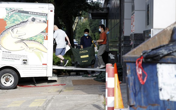 epa08564464 People load bags into a U-Haul truck outside the China Consulate General building on Montrose Blvd. in Houston, Texas, USA, 24 July 2020. The US Government ordered the closure of the consu ...