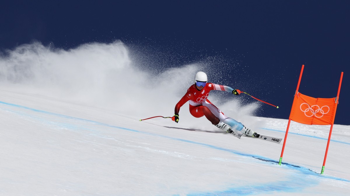 Corinne Suter, of Switzerland makes a turn during the women's downhill at the 2022 Winter Olympics, Tuesday, Feb. 15, 2022, in the Yanqing district of Beijing. (AP Photo/Alessandro Trovati)