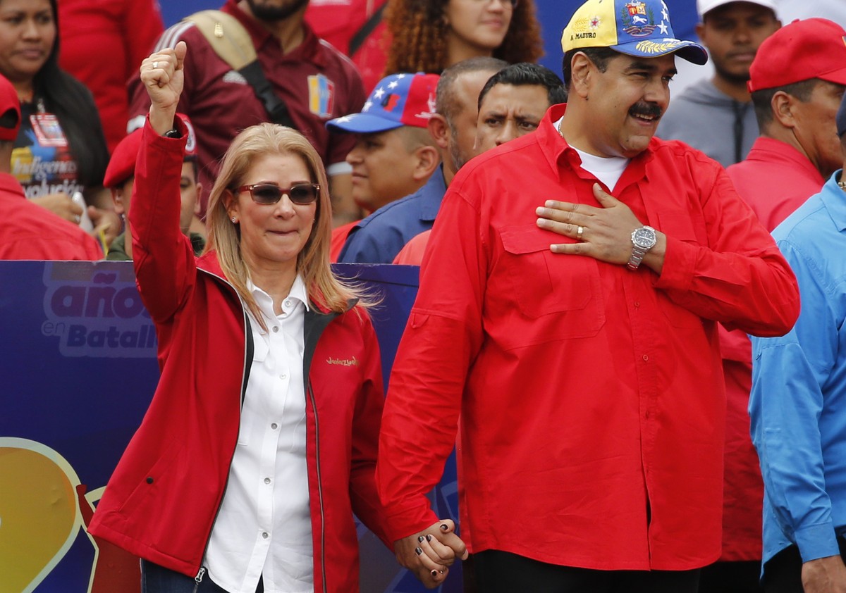 Venezuela's President Nicolas Maduro and first lady Cilia Flores acknowledge supporters at the end of a rally in Caracas, Venezuela, Saturday, Feb. 2, 2019. Maduro called the rally to celebrate t ...
