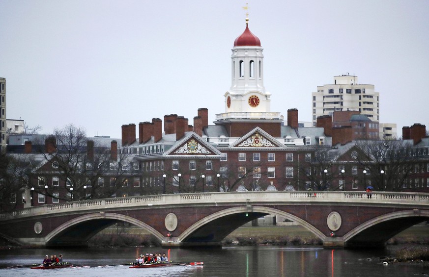 FILE - In this March 7, 2017 file photo, rowers paddle along the Charles River past the Harvard College campus in Cambridge, Mass. The Harvard Crimson, the school&#039;s student newspaper, reported Ju ...
