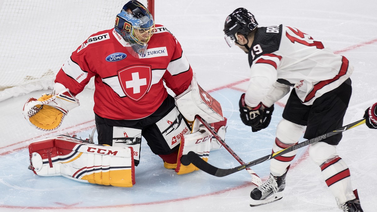 Switzerland’s goaltender Jonas Hiller, left, fights for the puck against Canada's Gilbert Brule during the 2017 Karjala Cup ice hockey match between Switzerland and Canada in the Tissot Arena in  ...