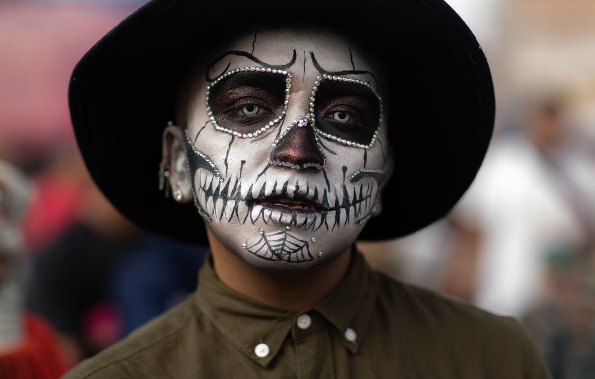 TEPITO, MEXICO - NOVEMBER 01: A man dressed in his 'Day of the Dead' costume poses on November 01, 2022 in Tepito, Mexico. People from across the city go to Tepito, the most notorious neighb ...