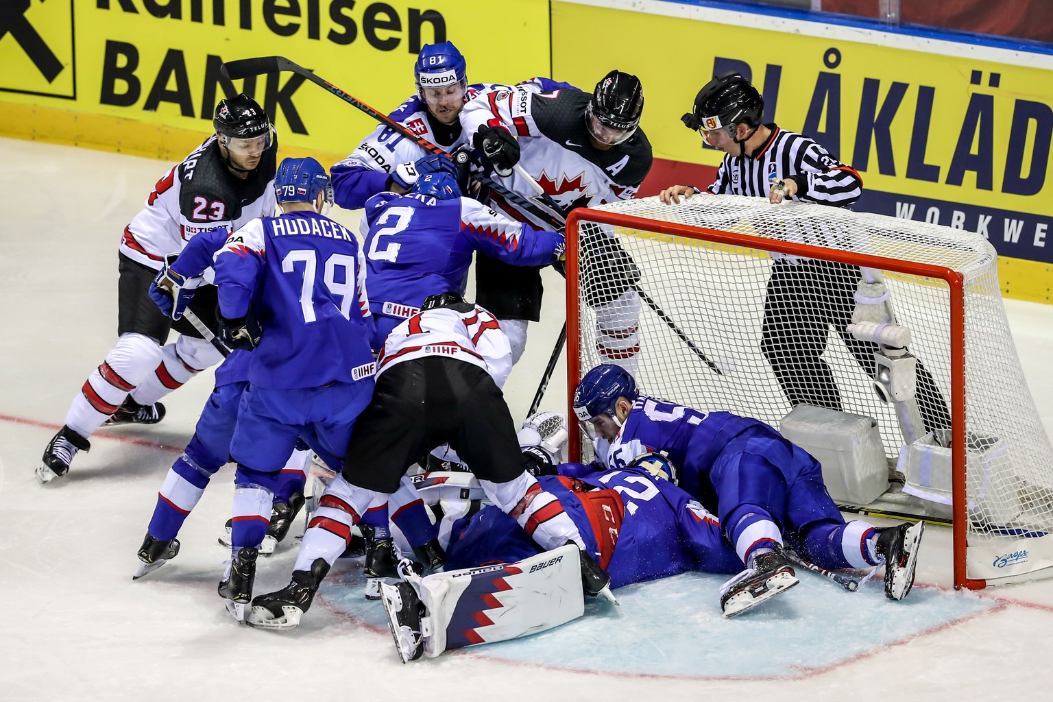 epa07568173 Players of Canada (white) and Slovakia (blue) in action during the IIHF World Championship group A ice hockey match between Slovakia and Canada at the Steel Arena in Kosice, Slovakia, 13 M ...