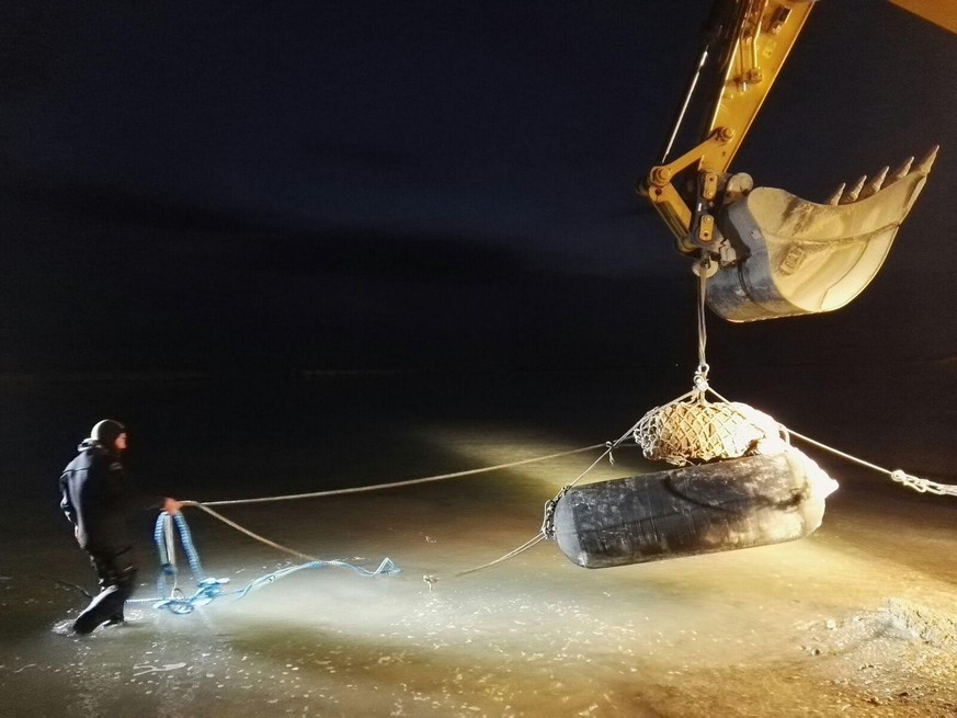 epa06602648 A handout photo made available by the Italian Defense Ministry shows Italian Army unit bomb disposal experts working on an World War II explosive device discovered on a construction site i ...