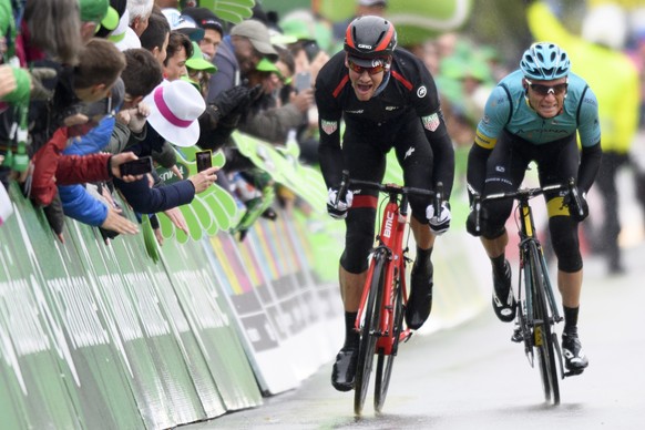 Stefan Kueng, left, from Switzerland of team BMC Racing sprints be crossing the finish line to win the second stage in front of second placed Ukrainian Andriy Grivko, right, of team Astana, a 136.5 km ...